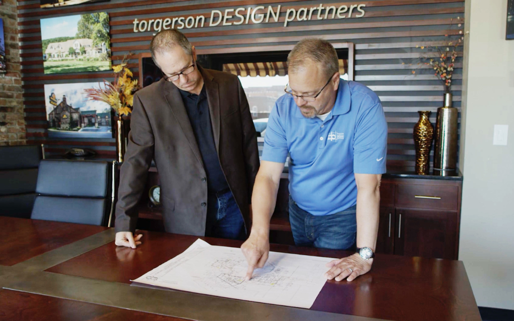 Torgerson Design Partners Employees Looking Through Blueprints