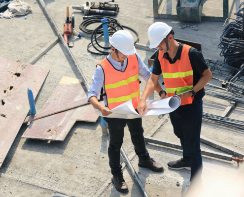 Aerial view of two engineers work on the construction site